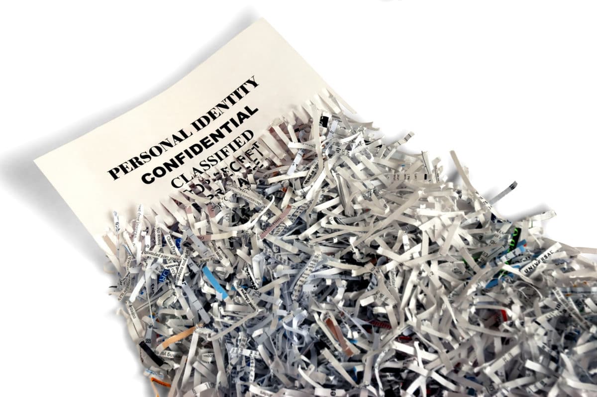 Image of a confidential document halfway shredded