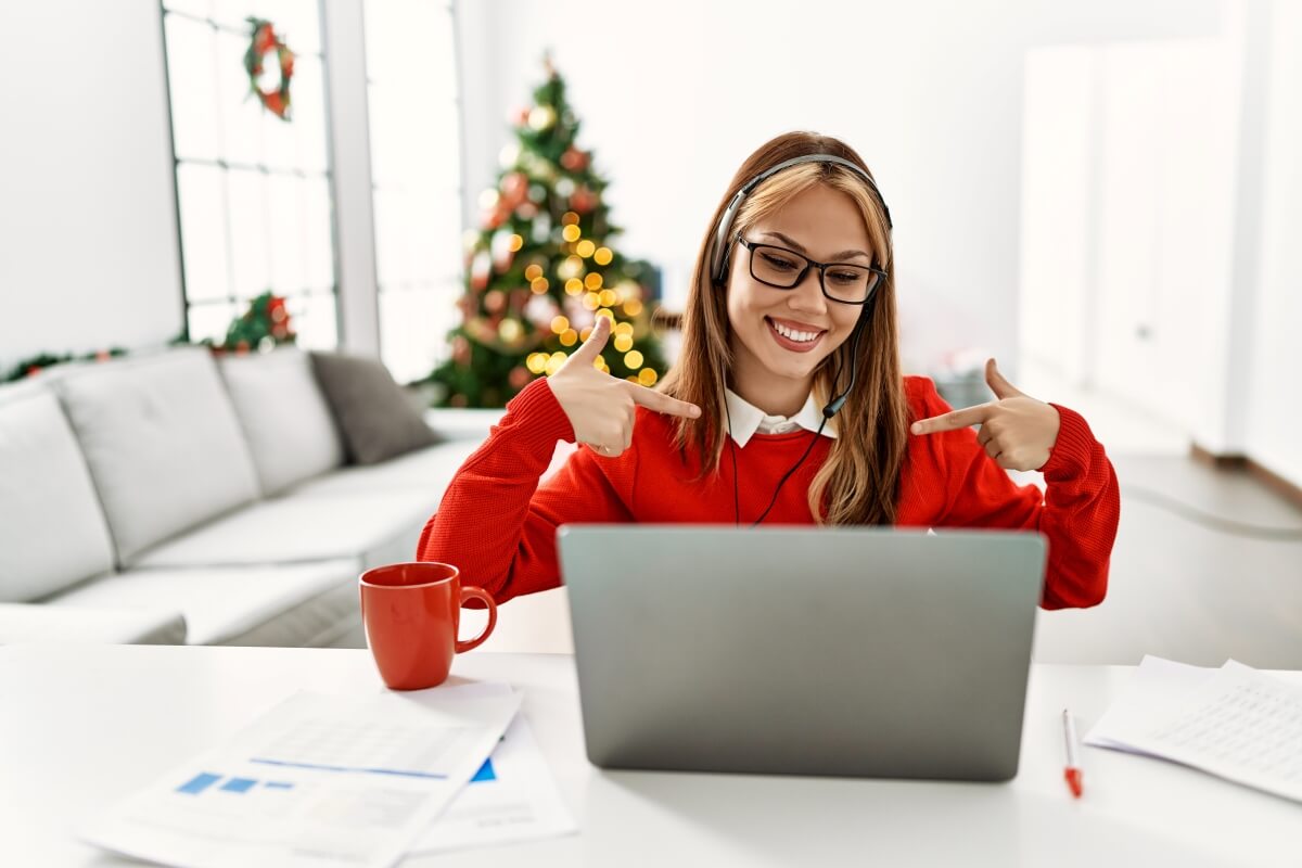 Happy person pointing to laptop during the holidays