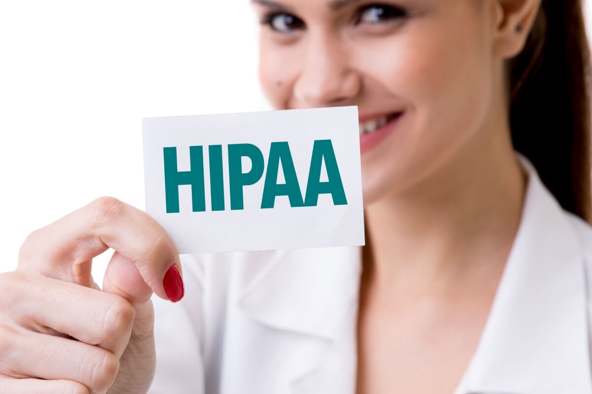 a person holding a sign for the shredding compliance law HIPAA