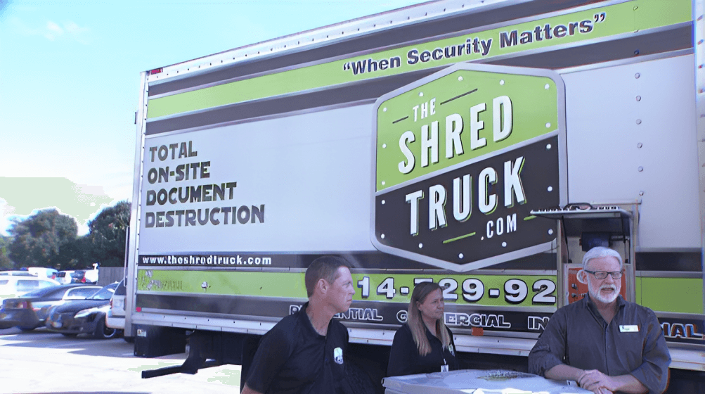 the-shred-truck-shredding a secure shredding truck outside with shredding bins